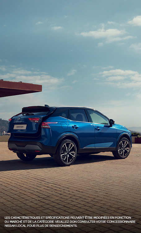 Blue Qashqai parked in front of building
