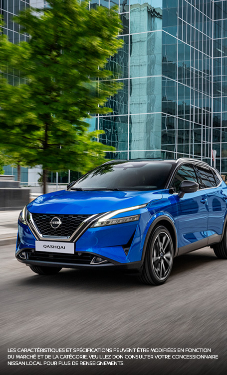Blue Qashqai driving in street